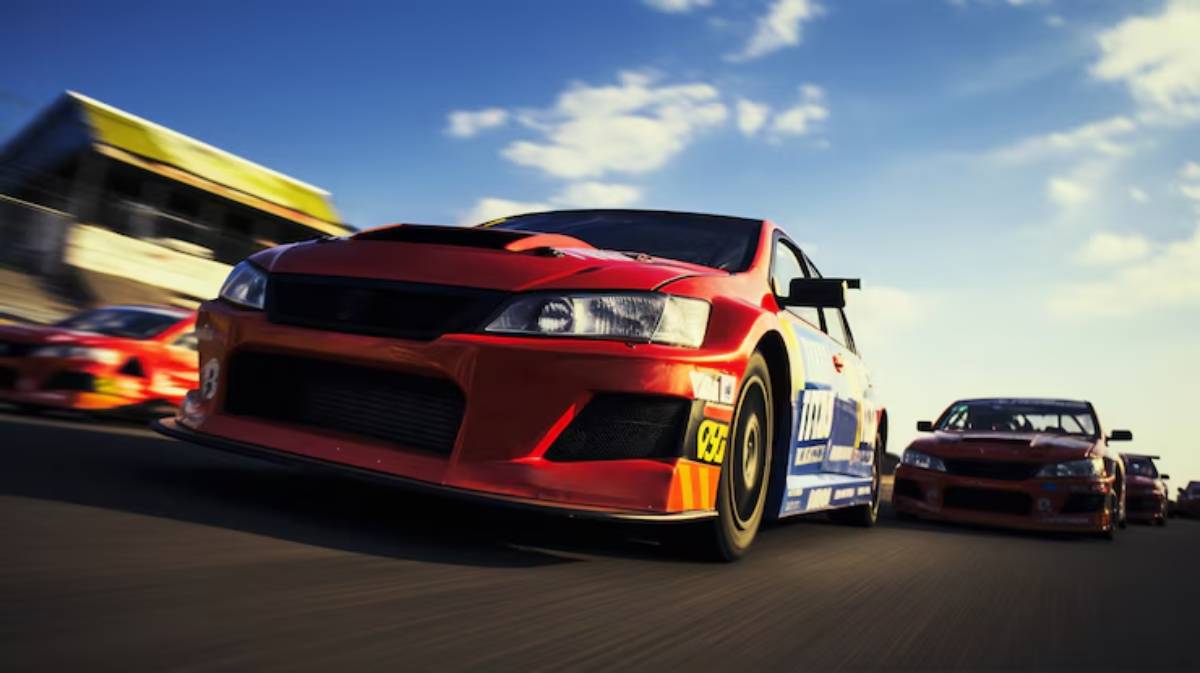 Racing cars zooming on a track under a bright blue sky, showcasing vibrant colors and speed in a competitive scene.