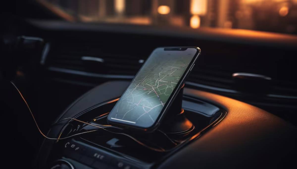 A smartphone displaying a map sits on a car's dashboard, illuminated by soft evening light, surrounded by sleek interior features.